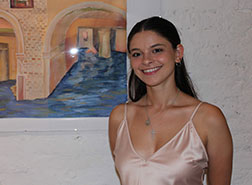 Alessia Amato ’20 poses by her oil painting Sunken Dream. Link to her story.