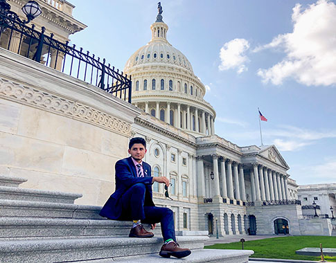 Lenni Joya ’19 sitting on steps in front of a US government building